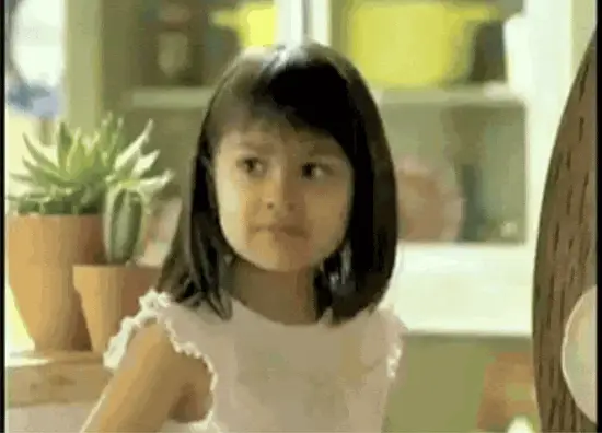 A child glancing sideways with a small smirk